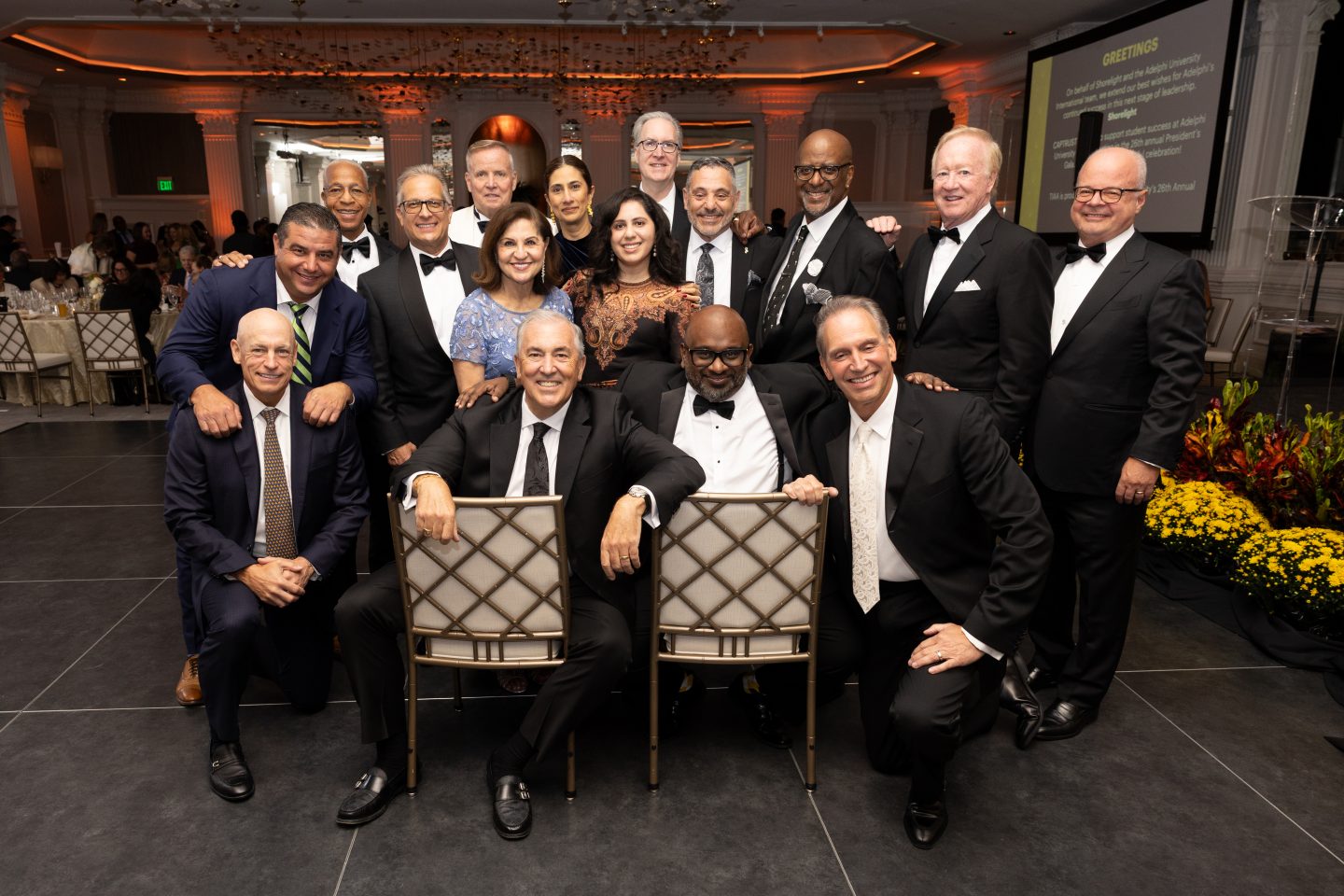 Members of Adelphi’s Board of Trustees gather at the 2026 University Gala with President Michael Balboni ’81, JD (seated, center), and Board Chair Leonard C. Achan ’99 (seated, right).