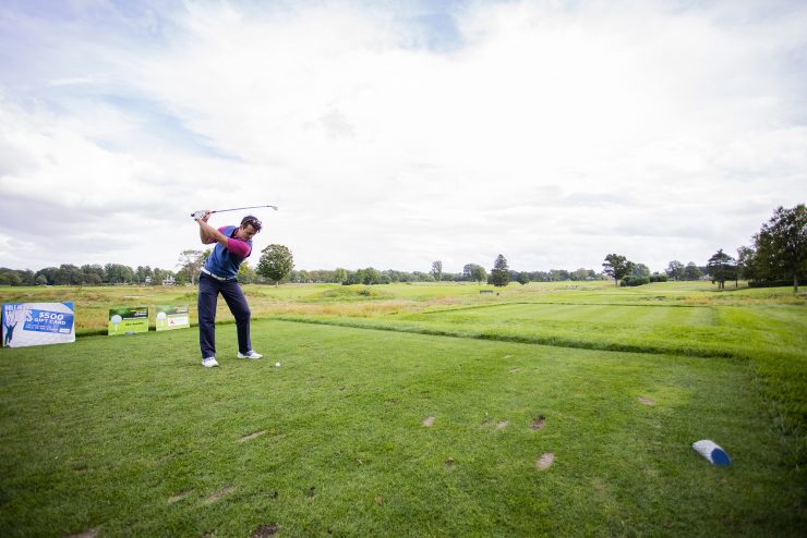 Someone taking a swing on the golf course