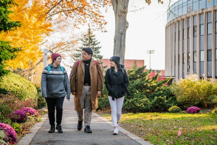 Adelphi students walking near the Science Building in the fall