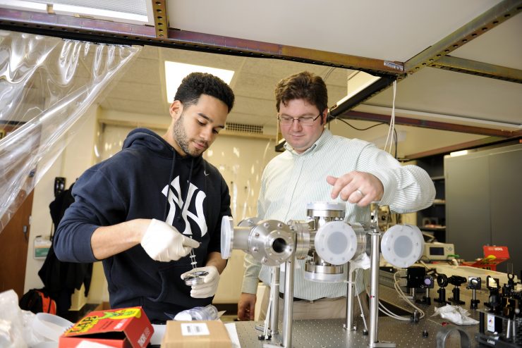 Matthew J. Wright working in the lab with a student.