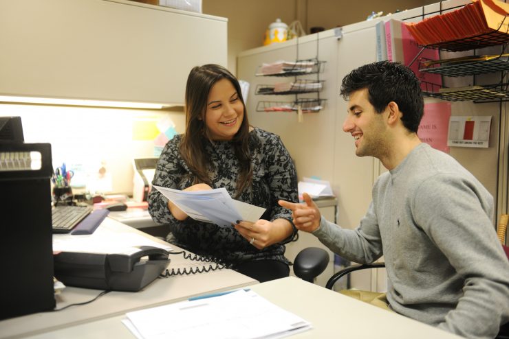 An Adelphi staff member consults a student in an office setting