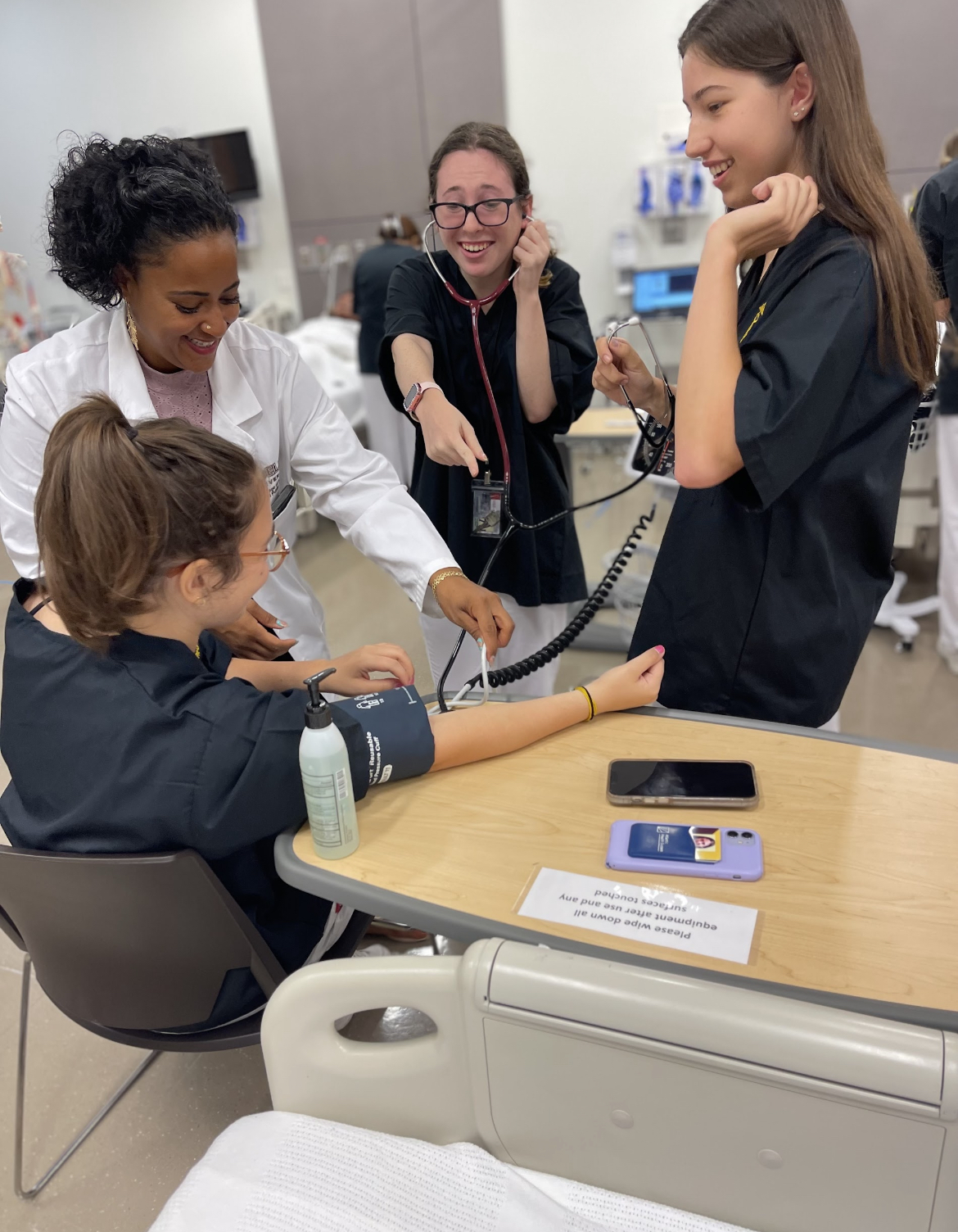 High school students learning how to take blood pressure at Adelphi University's summer nursing program.