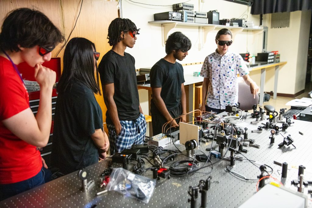 Pre-college students explore hands-on experiments with laser and optics technology in Adelphi’s advanced campus lab.