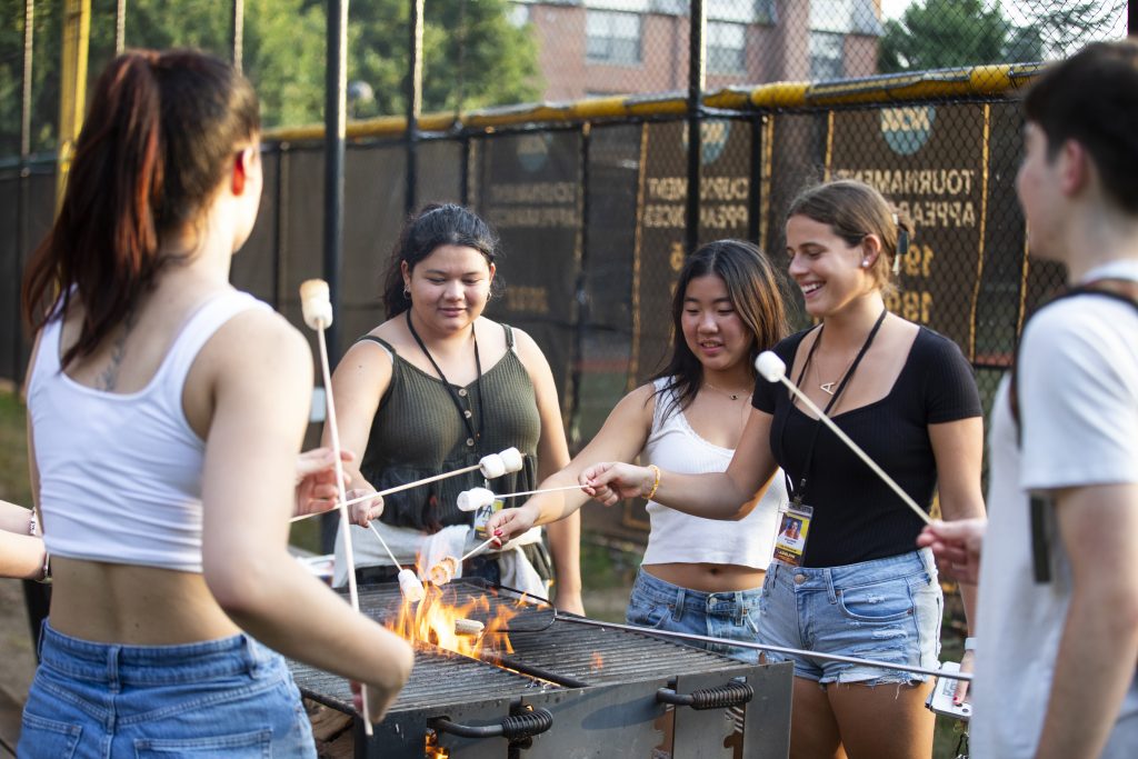 Pre-College students making s'mores on Adelphi's campus.