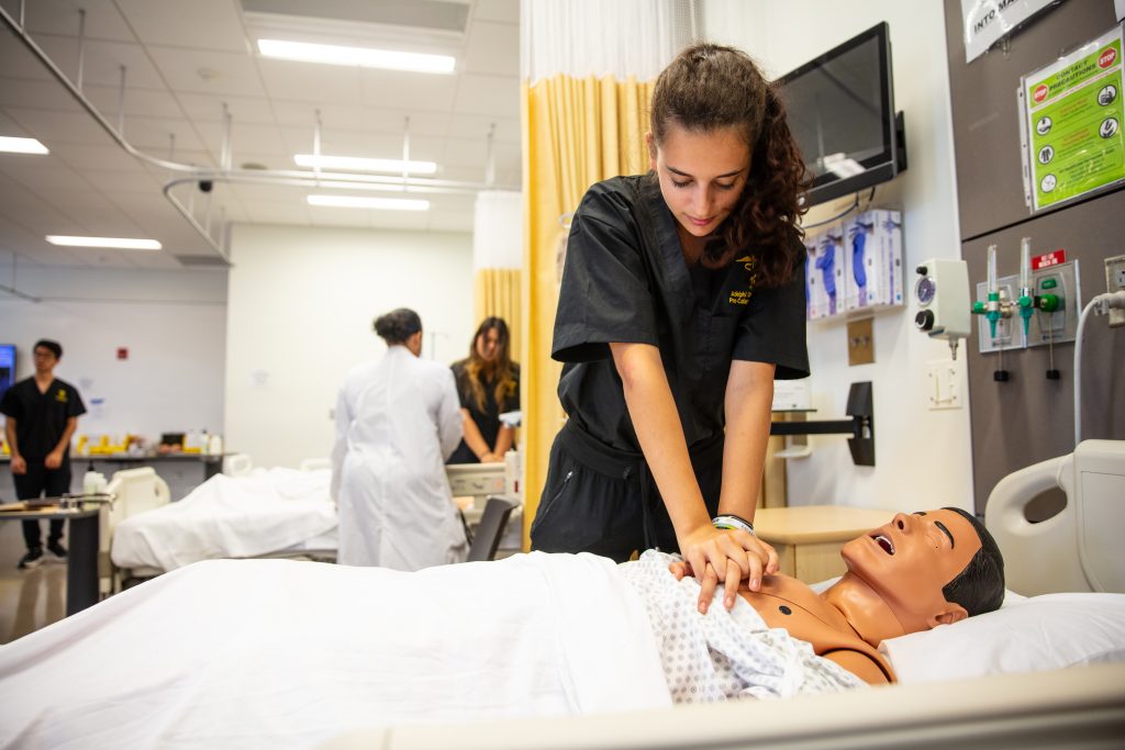 Pre-college nursing student providing CPR in Adelphi’s state-of-the-art Clinical Education and Simulation Lab.