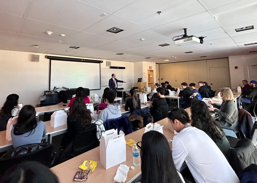 Dr. Peter Vellis ’96, DDS speaking in front of Adelphi University students on campus.