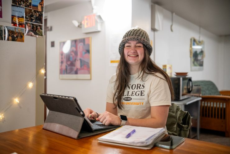 Honors student working on laptops in Earle Hall at Adelphi