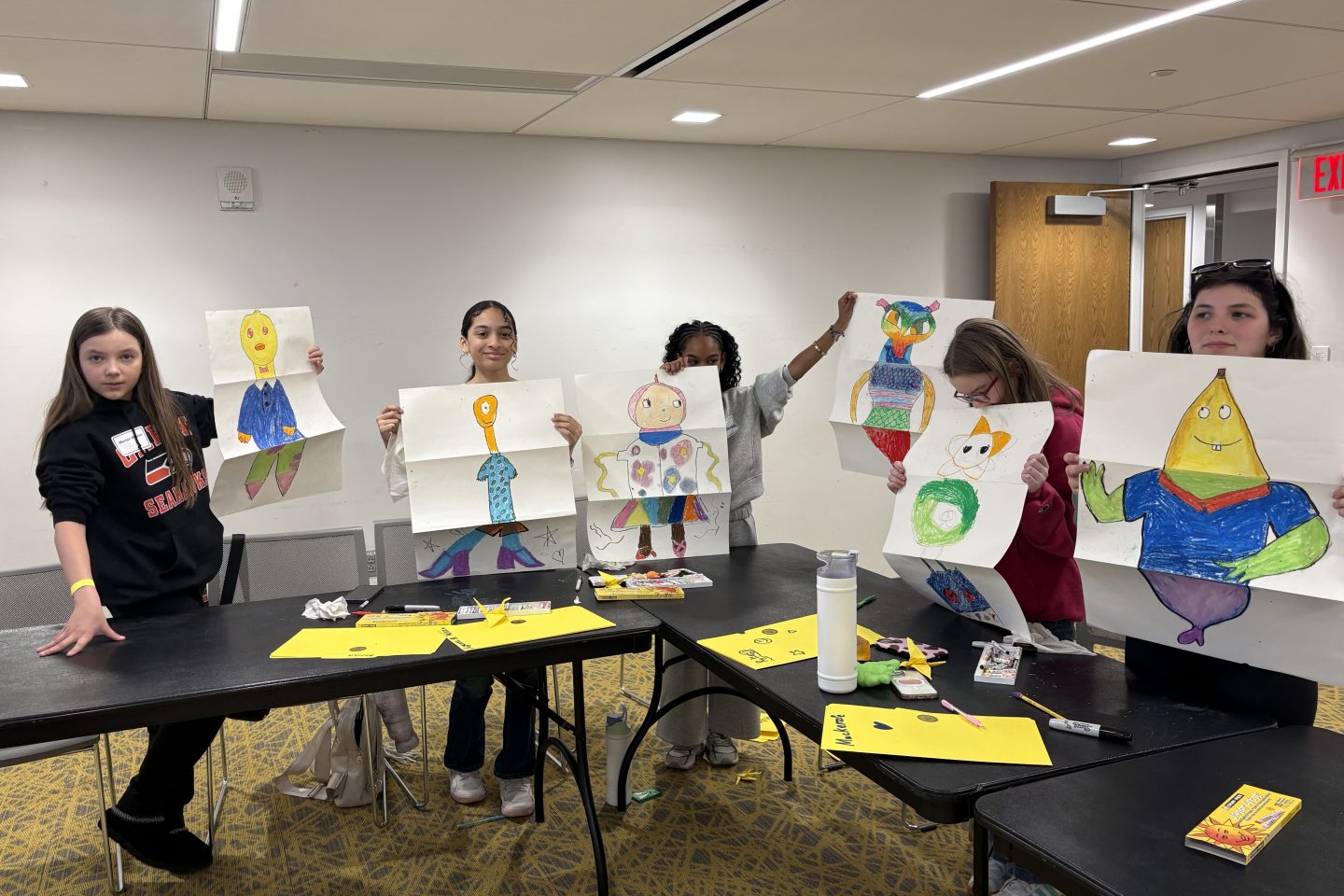 Adelphi employees’ children explore creativity through a hands-on pastel drawing activity.