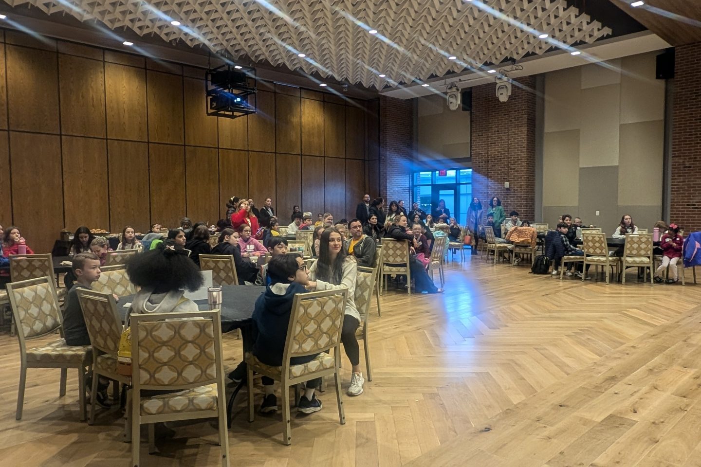 Children sitting at tables eating