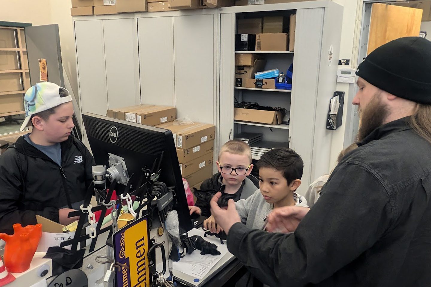Children gathered around a computer