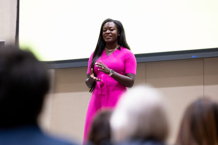 A confident leader speaks in front of a crowd