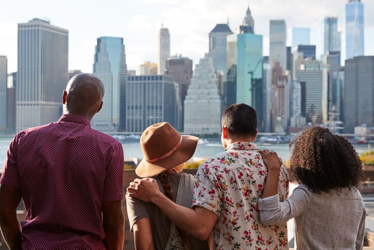 Rear View Of Tourists Looking At Manhattan Skyline