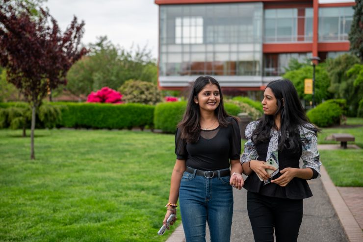 Two Adelphi students walking on the Garden City NY campus.
