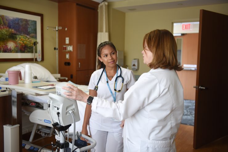 Adelphi student standing in the hallway of a local hospital during an internship