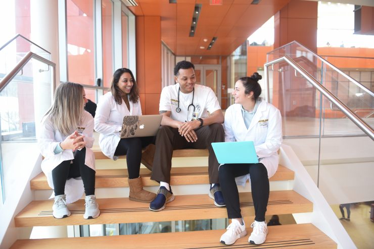 Nursing and Public Health students talking on the steps on the nexus building at Adelphi University