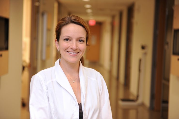 Adelphi graduate nursing student in white coat