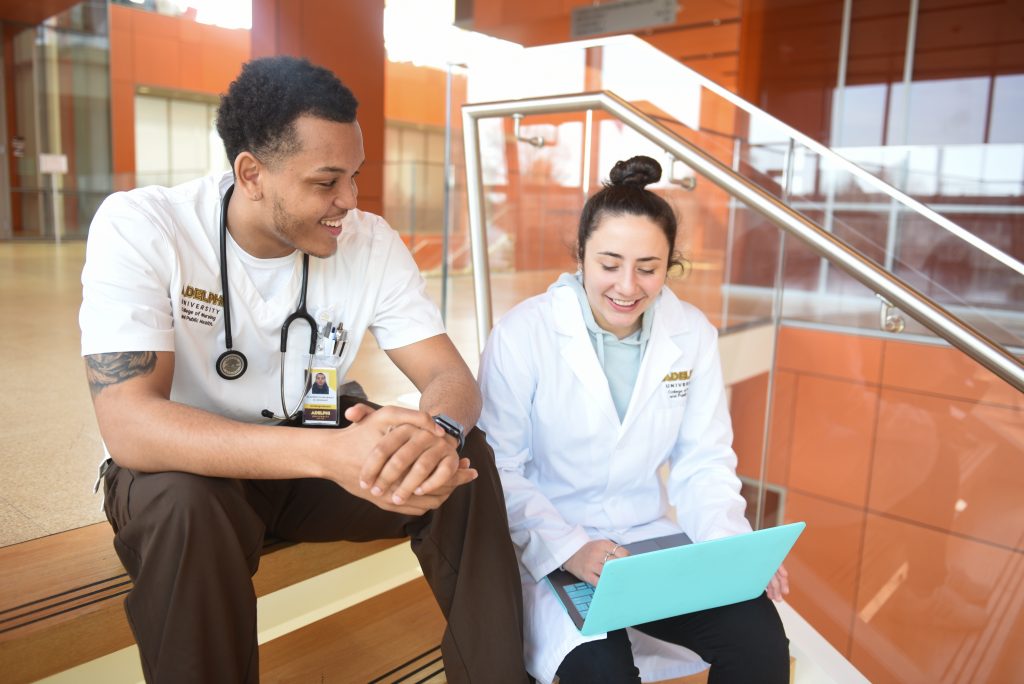 Nursing and Public Health students talking on the steps on the nexus building at Adelphi University