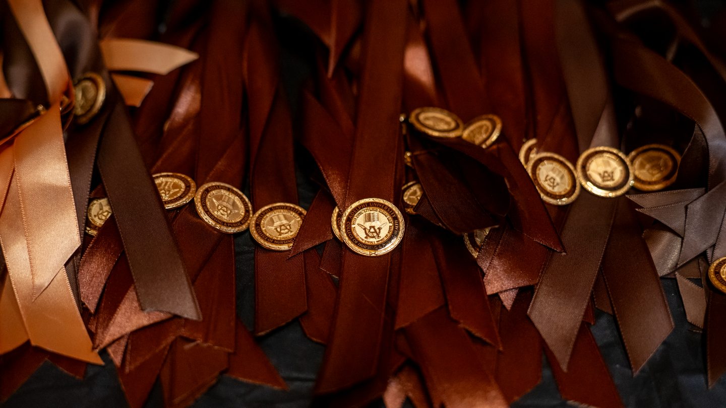 Adelphi nursing pins on gold ribbon
