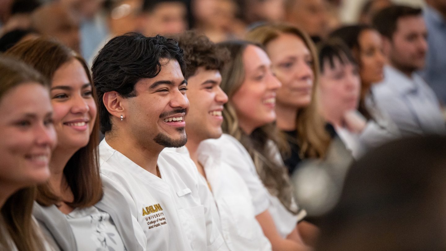 A row of Adelphi Nursing students beaming with smiles.