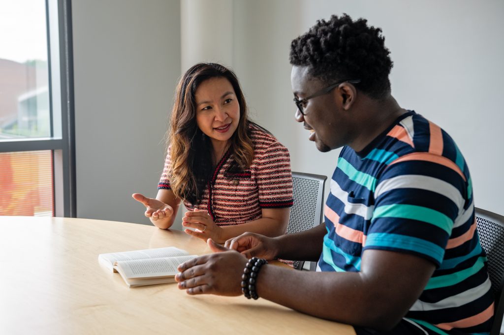 Professor Sokthan working with an honors student one on one. 