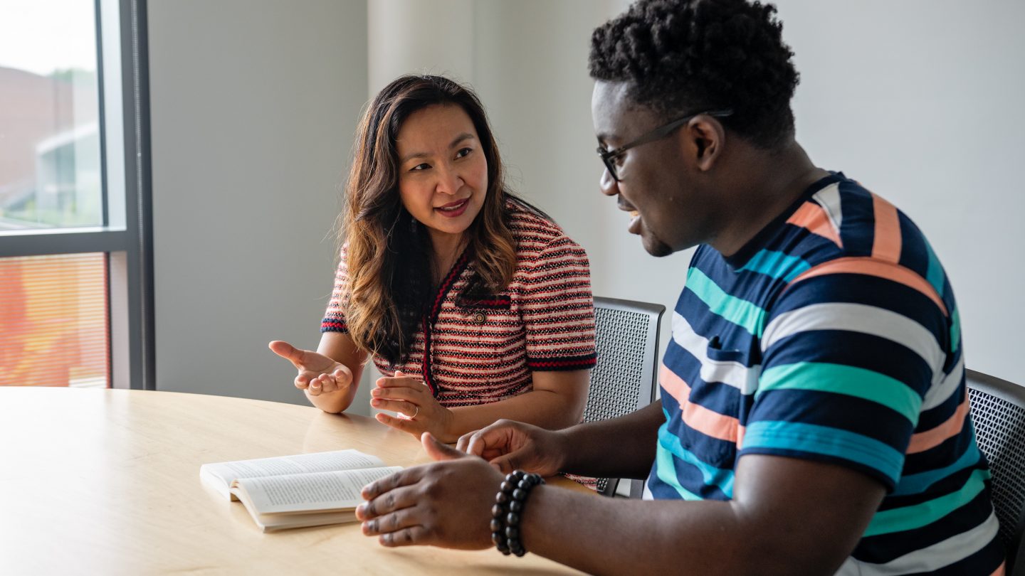 Professor Sokthan working with an honors student one on one.
