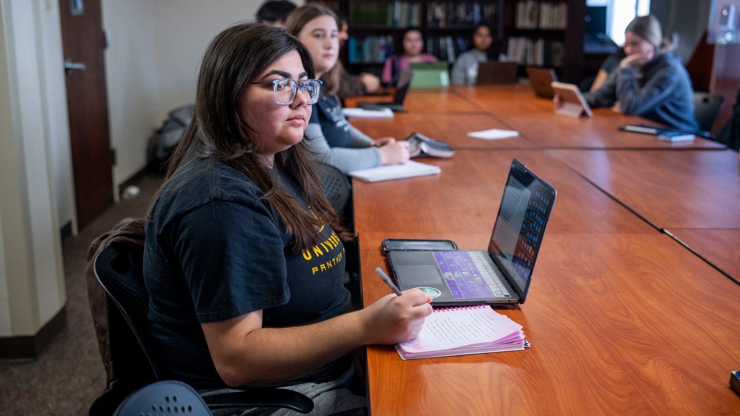 Honors College seminar room with students listening intently.