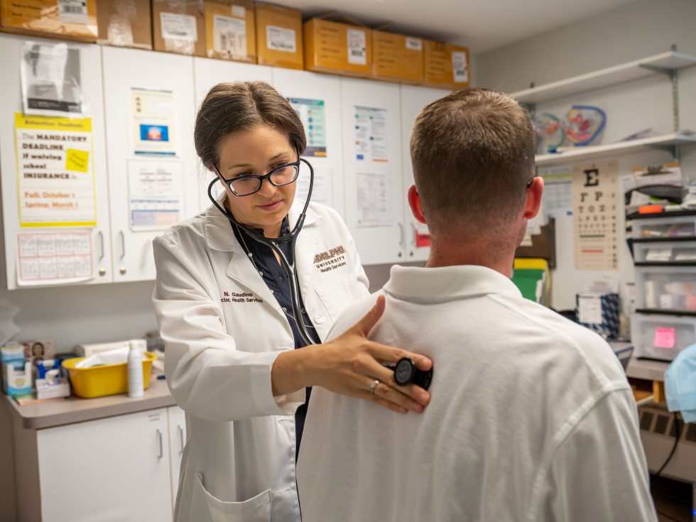 Adelphi Health Services center - nurse checking heart and breathing on a patient