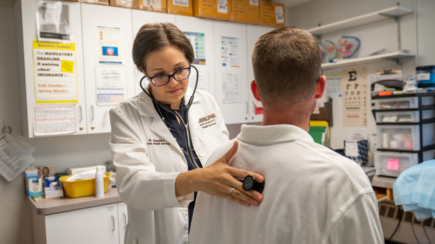 Nurse listening to heartbeat measurements at the Adelphi Health Services Center