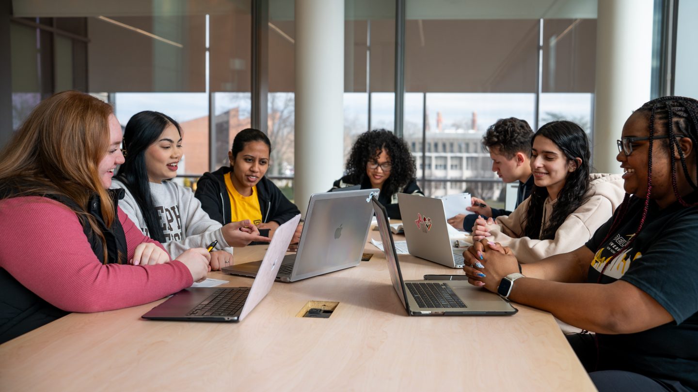 A group of students studying in Adelphi University's Nexus Building.