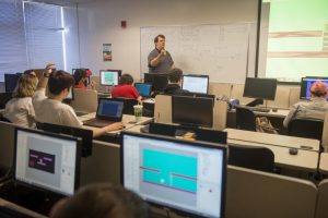 Faculty memeber in classroom with students.