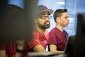 Student in baseball cap listening in class