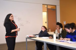 Faculty member speaking to students in a classroom