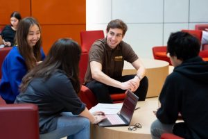 Group of students sitting talking in the Nexus Building