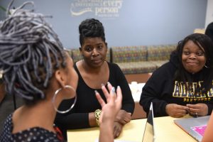 Three women sitting at a table talking