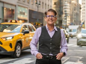 Jennifer Lancaster stands on a crosswalk on Fifth Avenue, just up the street from the new Manhattan Center.