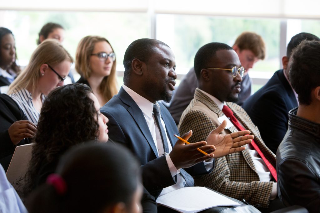 Professional training at Adelphi University - View of a man in a suit asking a question in a session