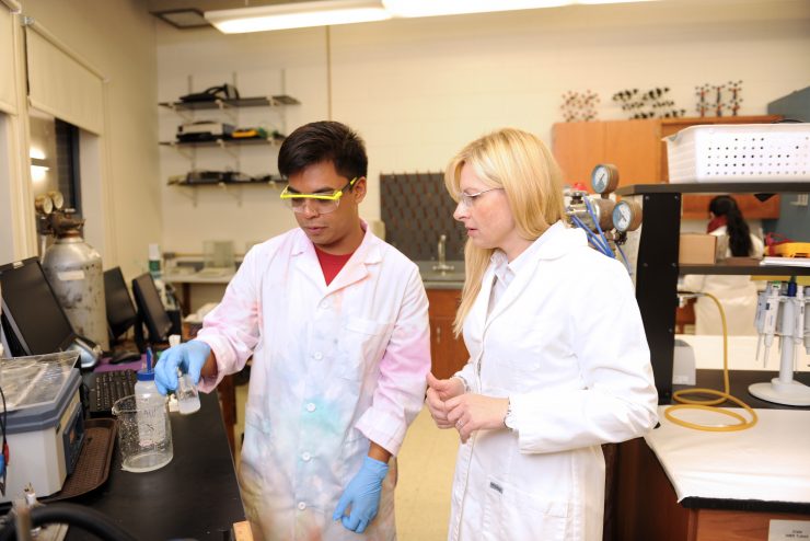 Student working with faculty member in a lab