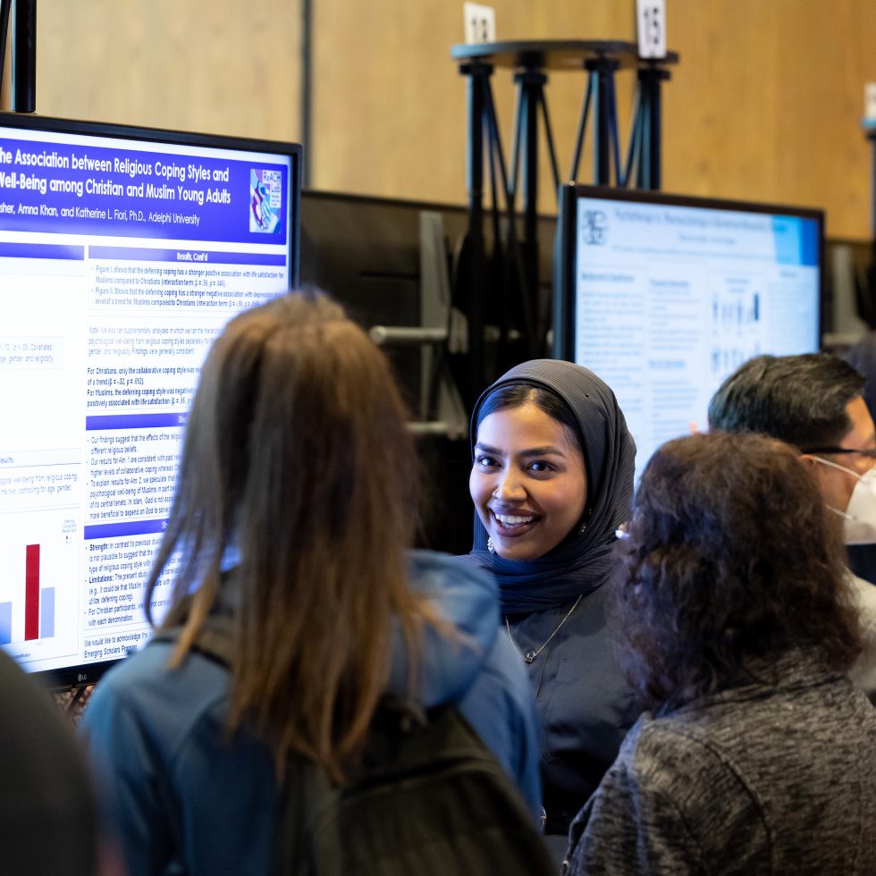 An Adelphi student presenting her e-poster at the annual research conference