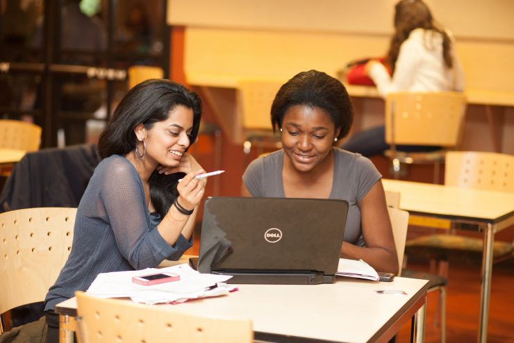 Students working together at a laptop