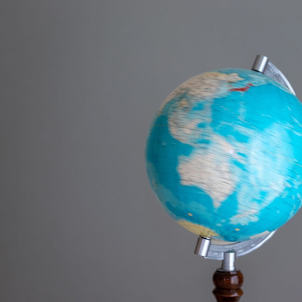 Rotating blue globe on gray background