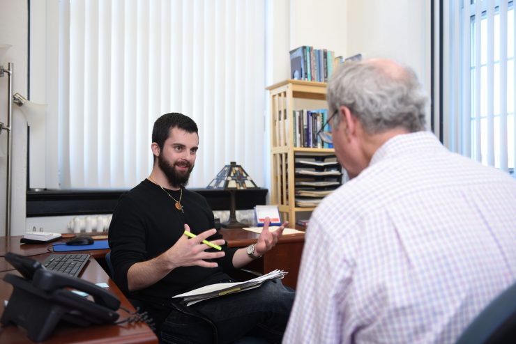 Professor Bornstein listening to a PhD psychology student explain a point.