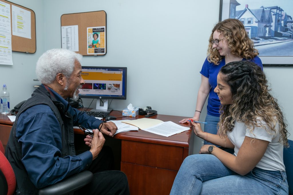 Kirkland Vaughans, PhD ’85, meets with psychology students from Derner in the Hy Weinberg Center for Communication Disorders.