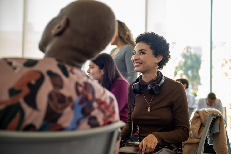 Two Derner School students listen during a mentoring session at Adelphi University