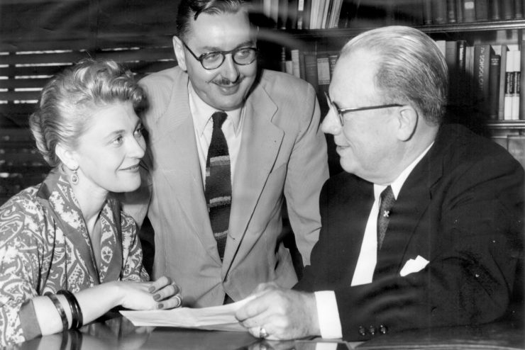 Gordon Derner, Ph.D., (center) talking with Adelphi colleagues.