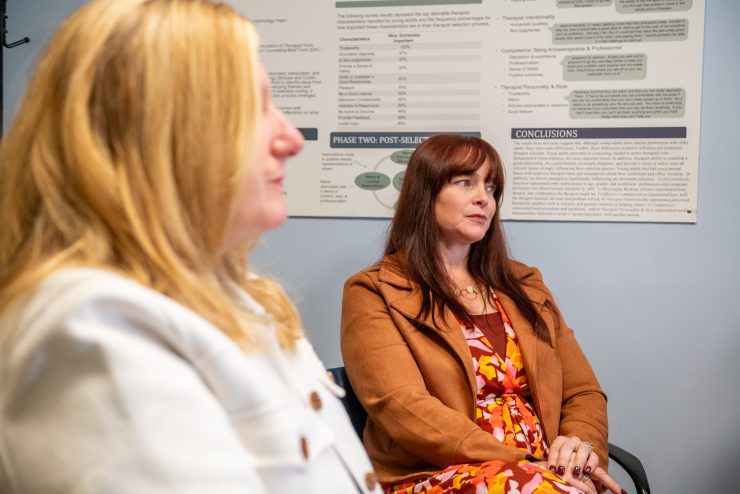 Two master’s level students in the Derner School of Psychology listening during an advisement session.