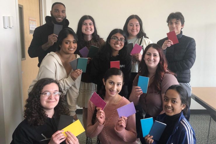 Rebecca Luther (bottom, left) practicing journaling with members of the Psychology Club and Her Campus.