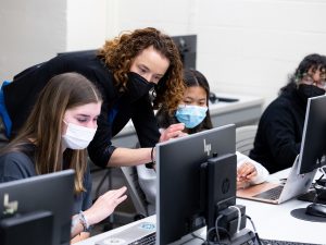 Katherine Fiori, PhD working with Adelphi University students while masked.