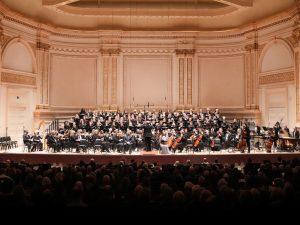 The orchestra, chorus and soloists of the Oratorio Society of New York, on stage at Carnegie Hall.