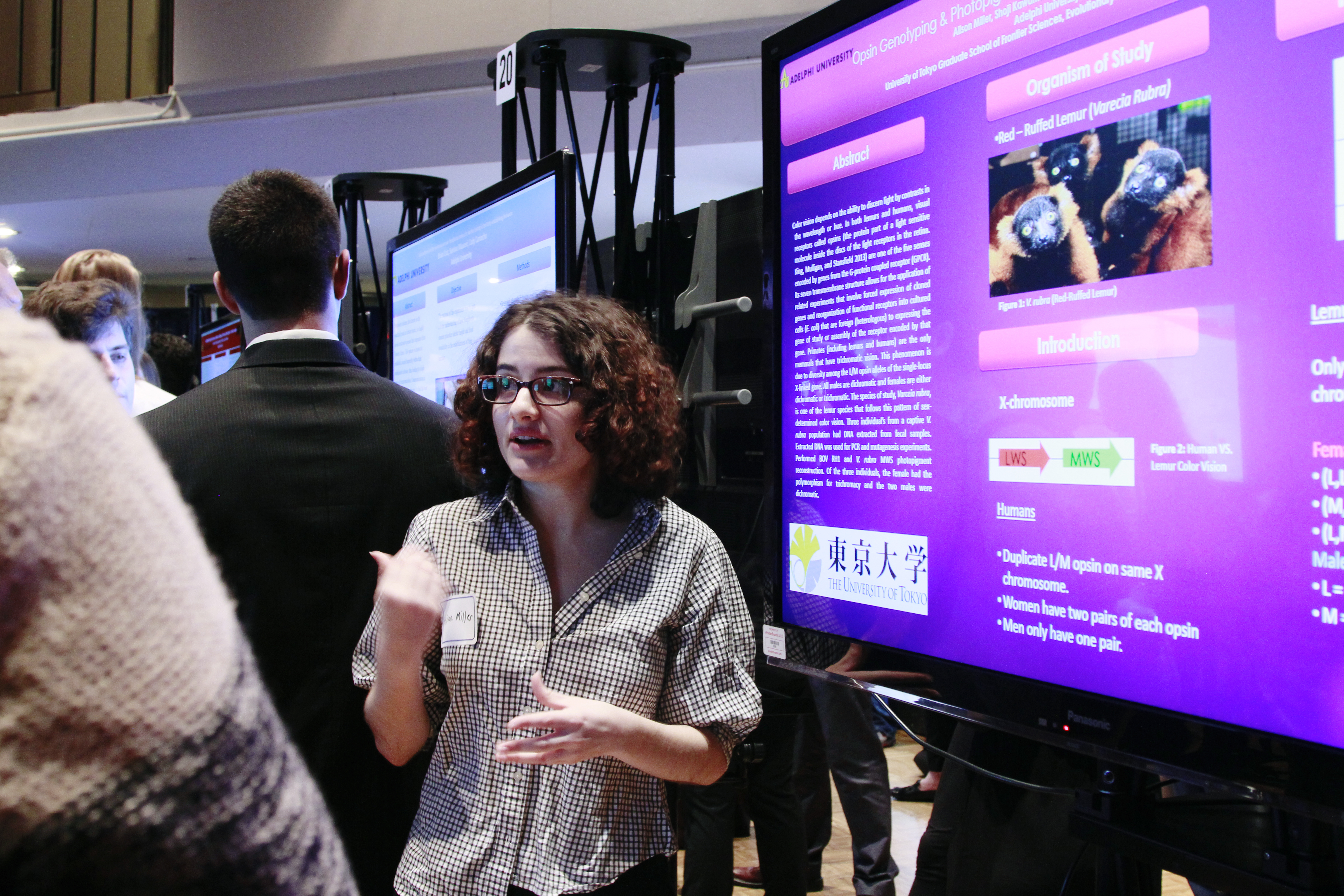 A student passionately explaining her research at Adelphi University's research conference