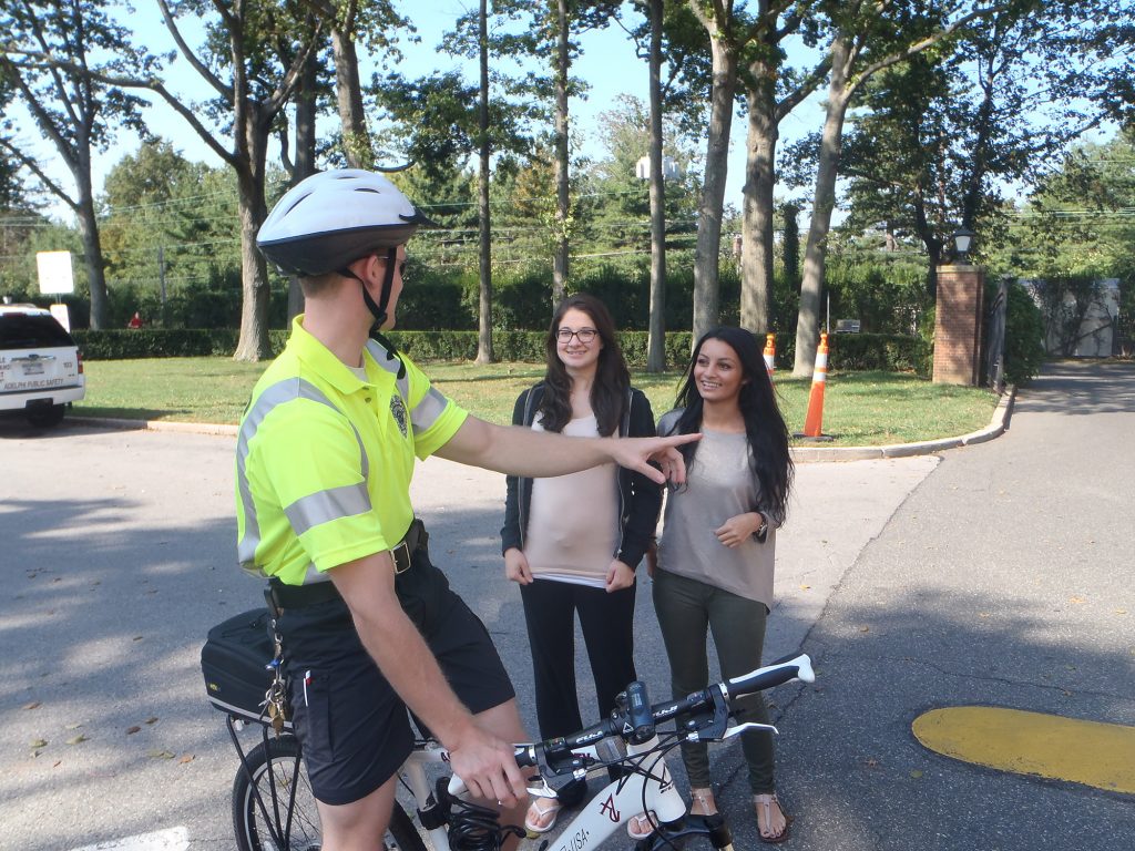 Bike Patrol Officer Speaking with Students on campus